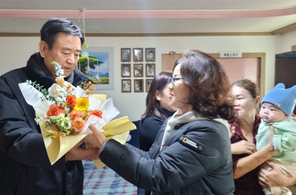 결혼 9년 만에 늦둥이를 얻은 윤병소씨(왼쪽)가 대천2동 관계자로부터 축하 인사를 받고 있다. /보령시 대전2동 제공